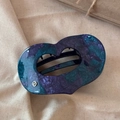 Détail de la pince à cheveux en acétate marbré en forme de cœur avec logo argenté - Bleu et Violet
