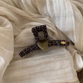 Detail of brown plaid hair claw clip with a green flocked heart and gold metal tag - Coffee Plaid Claw Clip