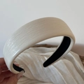 Primer plano de la diadema de cuero sintético plisado crema con textura acolchada - Blanco Roto