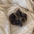 Close-up of brown plaid scrunchie with mustard velvet edges on beige linen fabric - Coffee Plaid Scrunchie