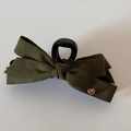 Detail van de donker olijfgroene fluwelen strik haarklem met gouden hart hanger - Groen