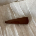 Detail of a large glossy dark brown hair claw clip on beige linen fabric texture - Shimmer Coffee - Triangle Clip