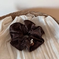 Close-up of velvet large hair scrunchie with decorative bead in a cozy woven basket - Coffee Velvet Bead Scrunchie