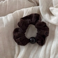 Detail of leopard print scrunchie with black bead on a soft cream linen background - Beaded Leopard (Dark) / Dark Color