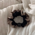Detail of leopard print scrunchie with ruffled lace edges and a large black pearl bead - Beaded Leopard (Light) / Light Color