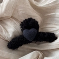 Close-up of black fuzzy wool claw clip featuring a heart accent and soft plush texture - Black