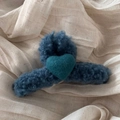Detail of navy blue plush hair claw clip with a teal wool felt heart on ribbed fabric - Blue