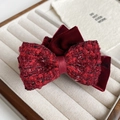 Detailed close-up of dark red tweed and velvet bow hair claw clip with golden silk threads - Red
