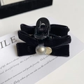 Detail of a black velvet bow hair clip with gray pearl and vintage gold coin pendant - Black Velvet Style