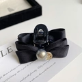 Detail of elegant black ribbon bow hair clip with grey pearl and golden charm - Black Fabric Style