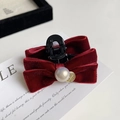 Detailed close-up of a burgundy velvet bow hair claw clip with a large central pearl accent - Red Velvet