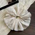Close-up of pleated cream oversized scrunchie with soft chiffon texture on wood - Beige Double-Layer Scrunchie