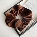 Detail of coffee brown velvet hair scrunchie with Blind For Love tag on a white tray - Brown