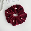 Detail of burgundy velvet scrunchie with white pearl accents on minimalist white background - Wine Red Velvet