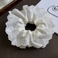 Close-up of double-layer lace scrunchie with intricate embroidery and pleated texture - Pure White