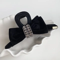 Elegant large black velvet bow hair claw with sparkling rhinestones in a white ceramic dish - Bow Claw Clip