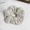 Close-up of knit scrunchie with tweed texture and colorful speckles on white surface - Hair Tie / Off White