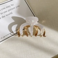 Detail view of the aurora white glazed hair claw with textured gold metal teeth - Pumpkin Pattern
