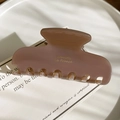 Detailed side view of rose pink acetate hair claw clip with golden branding text - Grey Pink