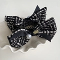 Macro detail of tweed bow hair claw with faux pearl and houndstooth texture - Bun Clip