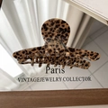 Macro view of French vintage leopard print hair claw with golden Barrette La France text - Thin Straight Style