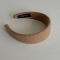 Detailed macro view of the inner side of a wide wool headband showing Hand Made label - Light Coffee