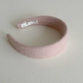 Dettaglio del cerchietto imbottito rosa con texture in lana spessa e design di qualità - Rosa