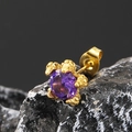 Detail-Makroansicht eines goldfarbenen Krallenohrrings mit lila Kristall auf schwarzem Stein - Gold Violetter Zirkonia