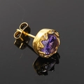 Gros plan d'une puce d'oreille dorée vintage avec une grande pierre violette et diamants - Or Zircon Violet (Unique)