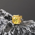 Close-up of vintage gold-plated ring with a large faceted yellow zircon on a dark rock surface - Gold Yellow Zirconia