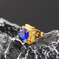 Macro shot of a square blue zircon earring with a vintage golden engraved setting on dark rock - Gold Plated Blue Zirconia