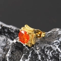 Macro detail of vintage gold stud earring featuring a faceted orange gemstone - Gold Orange Zirconia