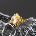 Macro shot of square zircon stud earring in gold finish on natural stone background - Gold Champagne Stone