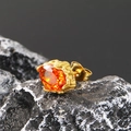 Close-up of golden stud earring with faceted orange zircon and hammered texture finish - Gold Tone Orange-Red Zircon (Single)
