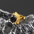 Macro shot of gold stud earring with black zircon stone on natural marble base - Gold Black Zirconia