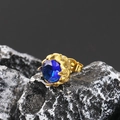 Macro shot of vintage style titanium earring with blue stone and gold leaf setting - Gold Plated Blue Zirconia