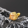 Macro shot of a vintage gold stud earring with a round amber cubic zirconia stone - Gold Champagne Stone