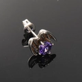 Macro detail of Gothic bat wing stud earring with a purple zircon stone on black mirror - Single Piece / Steel Purple Zirconia