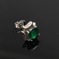 Macro detail of dark-style silver stud earring with vintage relief and green gemstone - Silver With Green Zircon