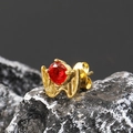 Macro shot of gold punk wing claw earring with red zircon on dark volcanic rock - Single Piece / Gold Red Zirconia