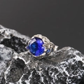 Macro shot of vintage titanium steel stud earring with deep blue round-cut gemstone - Stainless Steel Silver Color Blue Zirconia