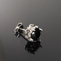 Macro view of vintage silver textured stud earring featuring a faceted black gemstone - Steel Color Black Zircon