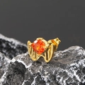 Macro shot of gold bat wing stud earring with orange cubic zirconia on dark stone - Single Piece / Gold Orange Zirconia