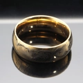 Polished gold stainless steel ring with vintage engraved texture on a reflective surface - US 6 / Gold
