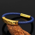 Navy braided leather bracelet with golden Greek Key engraved metal on weathered wood - Blue
