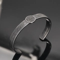 Macro detail of Nordic Viking bangle showing Celtic weave pattern and Tree of Life totem - Antique Tree of Life Style 10