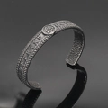 Detail of Viking Valknut symbol and Norse runes on a retro oxidized steel cuff bracelet - Antique Valknut Style 4