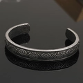 Macro detail of Nordic Viking cuff bracelet with evil eye relief and hammered texture - Antique Evil Eye Style 3