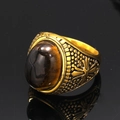 Macro shot of vintage gold men's ring with oval tiger eye stone and detailed embossing - Gold Tiger's Eye