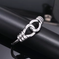 Polished silver stainless steel open bangle with intricate intertwined knot design for unisex - Steel